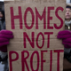 A woman in the UK protesting evictions and lack of affordable housing in 2015.